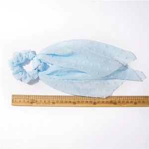 Light blue seersucker scrunchie with long ribbons and embossed polka dot texture