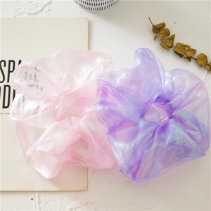 Detail of dreamy iridescent organza scrunchies in pink and lilac with metallic glow