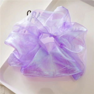Macro shot of lavender organza scrunchie with iridescent shimmer and pleated texture