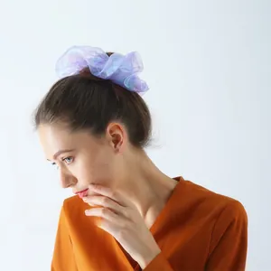 Detail of shimmering purple organza scrunchie with iridescent finish on hair