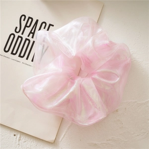 Macro detail of pink organza hair scrunchie with iridescent pearlescent finish