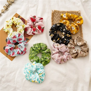Set of 8 satin hair scrunchies with fruit and floral patterns on cream fabric