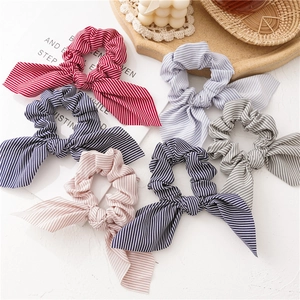 Flat lay of six striped scrunchies with rabbit ear bows in varied soft pastel colors