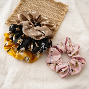Close-up of floral scrunchie set in khaki black yellow and pink chiffon fabric