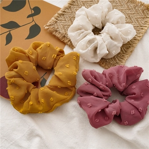 Three premium Swiss dot seersucker scrunchies in yellow, cream, and dusty rose colors