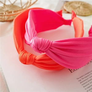 Detail of neon pink and orange knotted fabric headbands with textured knit material