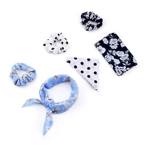 Detail view of floral and polka dot chiffon hair scrunchies with long ribbon streamers