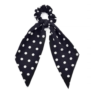 Detail of black polka dot hair scrunchie with long chiffon ribbon streamer for ponytails