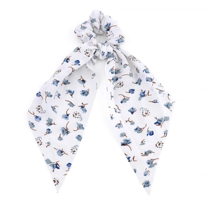 Floral print hair scrunchie with long ribbon tails and blue flowers on white fabric