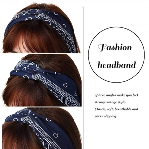 Three-angle view of navy blue paisley twisted headband showing soft elastic fabric texture