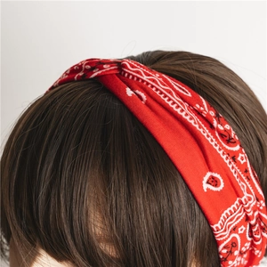 Detail of red paisley knotted headband featuring high-quality breathable cotton fabric