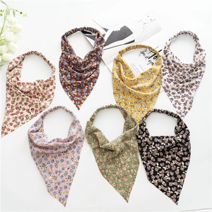 Flat lay of seven floral elastic headbands in various colors with bohemian print style