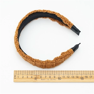 Caramel knitted headband for women with wood ruler showing 15cm width for size reference