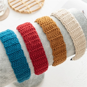 Detail view of retro hand-knitted wide headbands in four different elegant colors