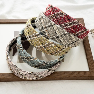 Five assorted tweed padded headbands in vintage textures for women displayed on wood