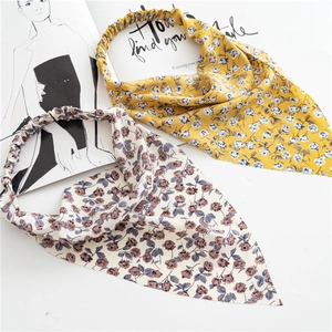 Detailed view of floral elastic headscarves in yellow and cream chiffon fabric