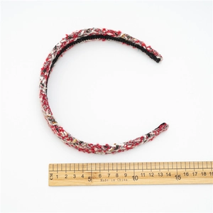 Luxury tweed headband in red white and black with gold threads on white background