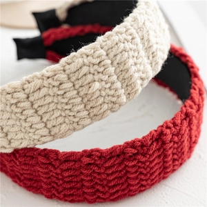 Detailed macro view of retro knitted wavy patterns on beige and red headbands