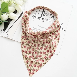 Close-up of vintage floral triangle hair kerchief with elastic band on white background