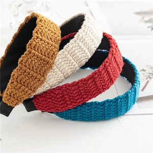 Set of four colorful knitted wide headbands with textured crochet patterns for women