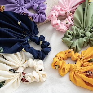 Close-up of colorful chiffon scrunchies with butterfly patterns in multiple vibrant colors