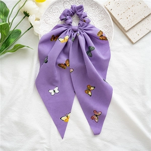 Detail of purple chiffon scrunchie with colorful butterfly prints and long ribbon streamers