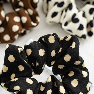 Macro shot of knitted polka dot scrunchies showing detailed striped fabric texture