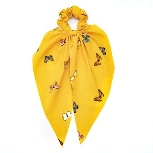 Bright yellow chiffon hair scrunchie with colorful butterfly prints and long ribbon ties
