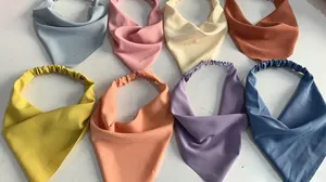 Detailed flat lay of elastic hair bandanas in 8 pastel colors including blue and pink