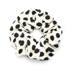 Polka dot fabric scrunchie in cream white with black spots and ribbed knit texture