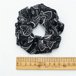 Retro black and white paisley print fabric scrunchie with 10cm diameter measurement
