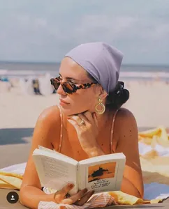 Fashionable light purple elastic headscarf worn by a model at the beach for holiday style