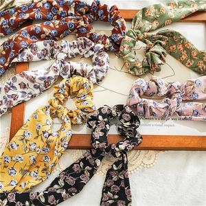 Floral fabric hair scrunchies with long ribbons in six assorted colors on vintage decor