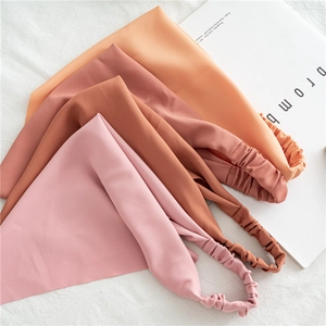 Set of four solid color elastic hair bands in pastel pink and terracotta fabric tones