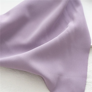 Macro shot of light purple fabric texture and soft drapes of the elastic hair bandana