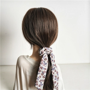 Floral scrunchie with long ribbons and purple roses on cream fabric worn in hair
