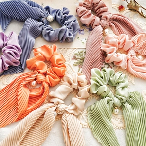 Pleated satin scrunchies with streamers and pearl pendants in assorted soft colors