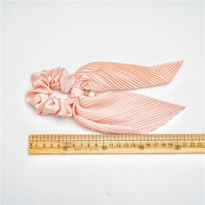 Pink pleated satin hair scrunchie with long ribbons and pearl detail measuring 20cm