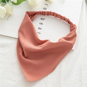 Close-up of brick red chiffon elastic bandana headband showing smooth fabric texture