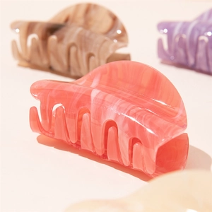 Minimalist acrylic claw clips in pastel marble colors for elegant hair styling