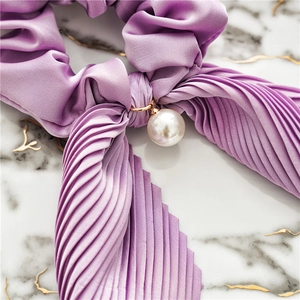 Elegant purple satin scrunchie with pleated texture and a large pearl pendant detail