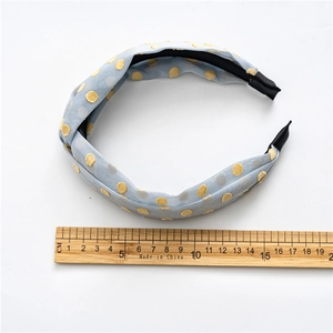Polka dot wide headband for women in light blue and yellow with wood ruler for scale