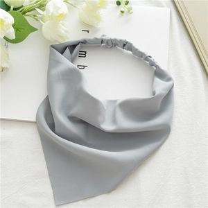 Detail view of grey elastic fabric headscarf showing soft texture and premium stitching