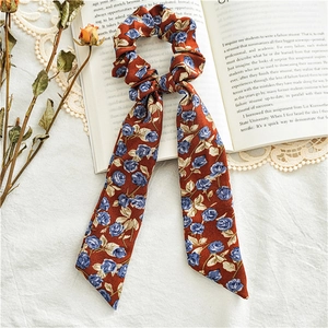 Detail of floral ribbon hair tie with vintage rose pattern on soft chiffon fabric