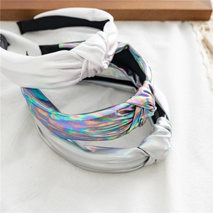 Three-piece set of wide knotted headbands in metallic silver and laser iridescent finishes