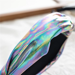 Macro shot of iridescent laser knot headband with cross knot detail and black non-slip lining