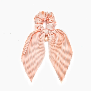 Pink satin pleated hair scrunchie with long streaming ribbons and a white pearl accent