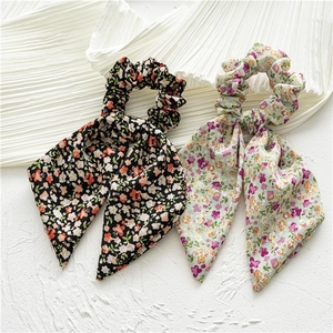 Floral print hair scrunchies with long streamers in black and green fabric patterns