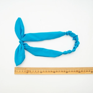 Elastic blue rabbit ear headband with soft fabric texture and flexible knotted design