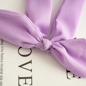 Detailed macro view of the lavender fabric texture and knot on a rabbit ear headband